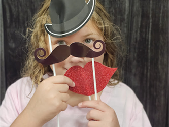 student with fake mustache and hat