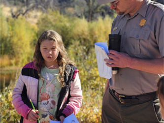 student standing next to ranger