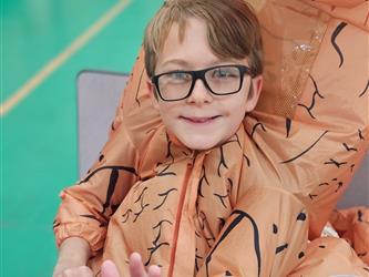 Student in dinosaur Halloween costume